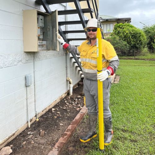 Crew member standing next to switchboard on residential house