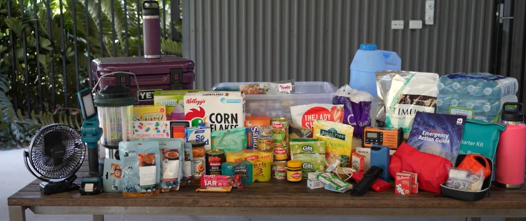 A worker standing at a table with food and accessories to pack for a stork