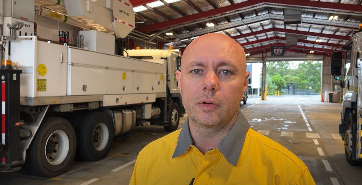 Employee Kev Lavender in a depot with work trucks