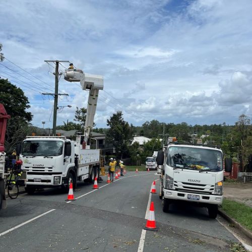 A number of crew members in work vehicles working on powerlines