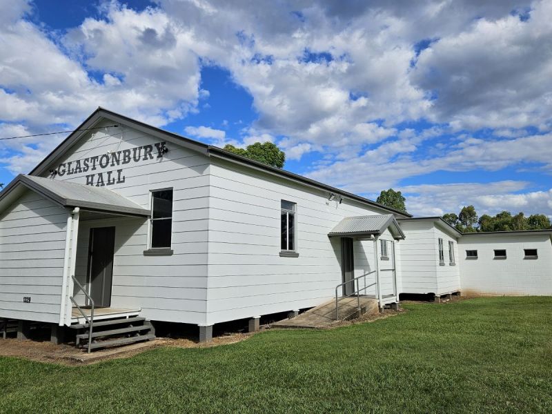 Glastonbury hall white building with cloudy sky backdrop