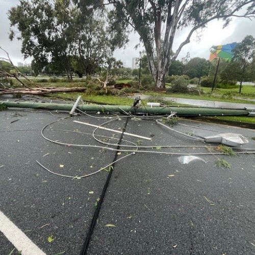 Power pole and powerlines down across the road at Southport