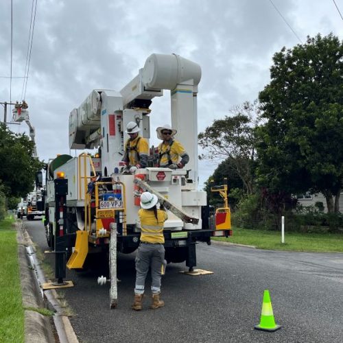 Crews working on big truck in residential street