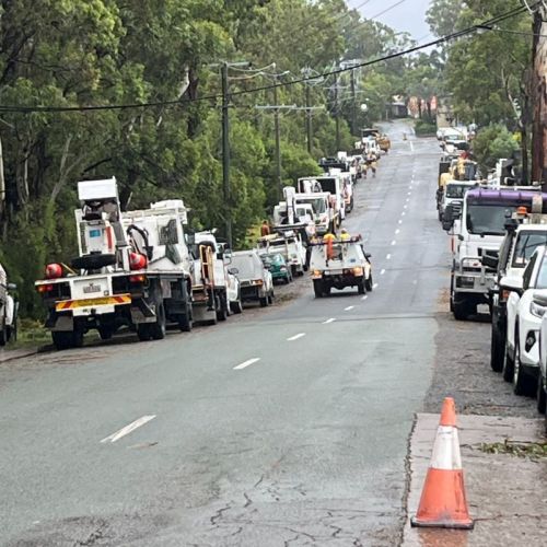 Street full of work trucks and vehicles restoring power