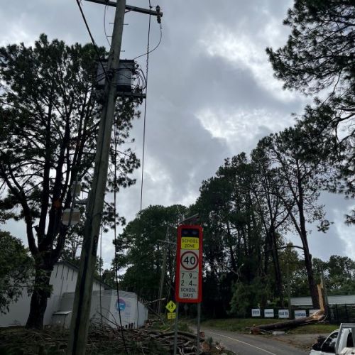 Debris at the bottom of a power pole on a street