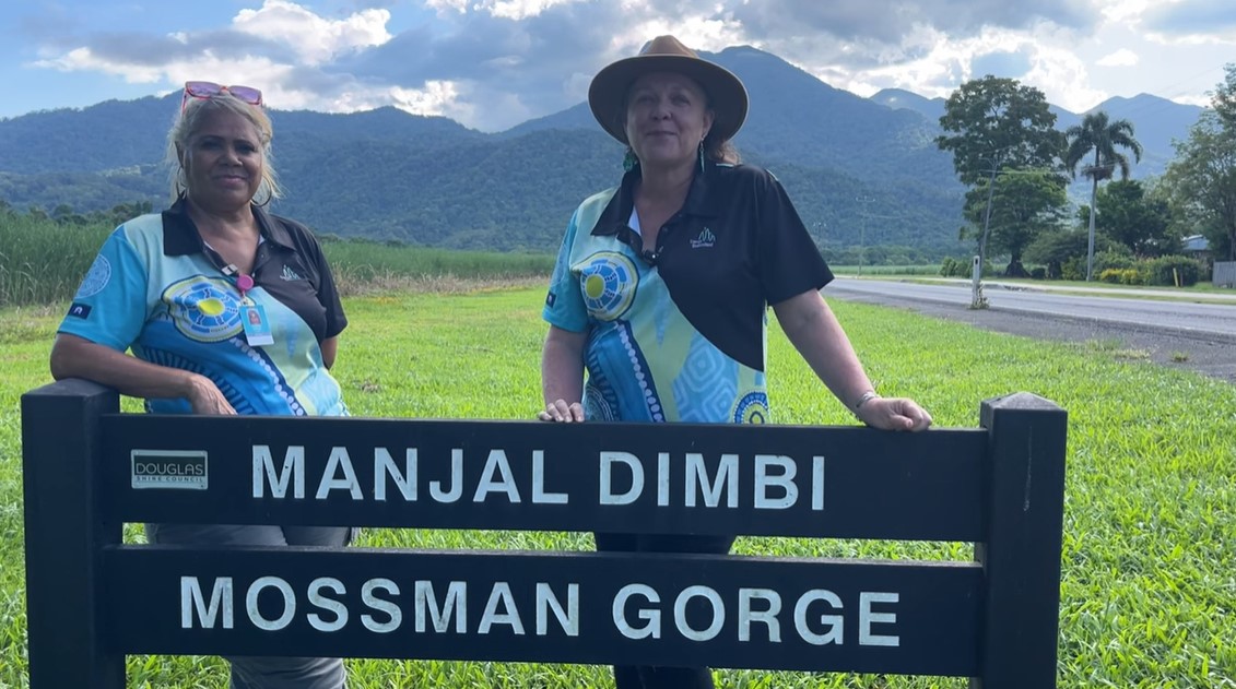 Ergon Energy workers standing in front of Manjal Dimbi Mossman Gorge sign