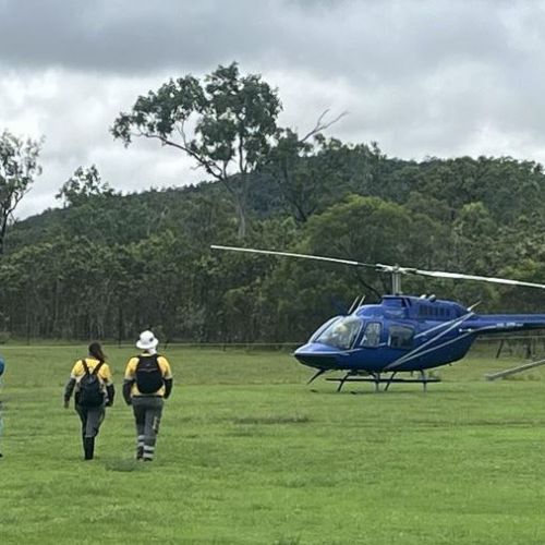 Workers heading to helicopter in field