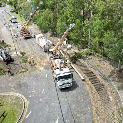 Aerial view of crews working on powerlines in car park