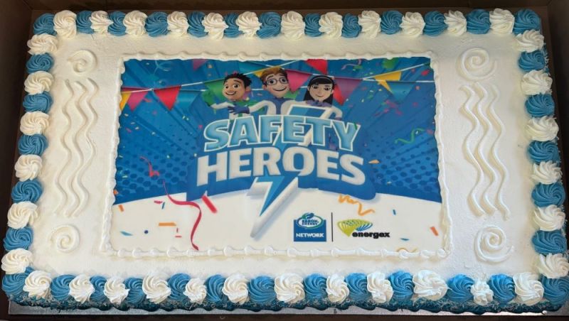 A blue and white cake with Safety Heroes writing