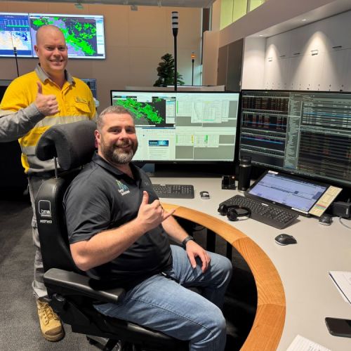 Nick Grant and Scott Ryan sitting at desks in our Control Centre