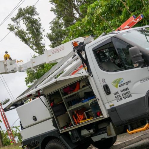 Energex vehicle with crews in background in cherry picker working on powerlines