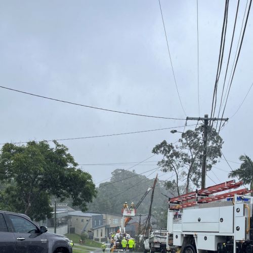 Crews working in cherry picker on powerlines