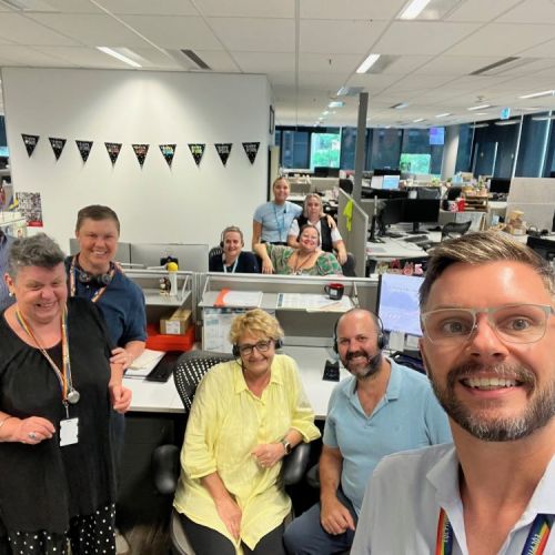 Group shot of employees in the contact centre around desks