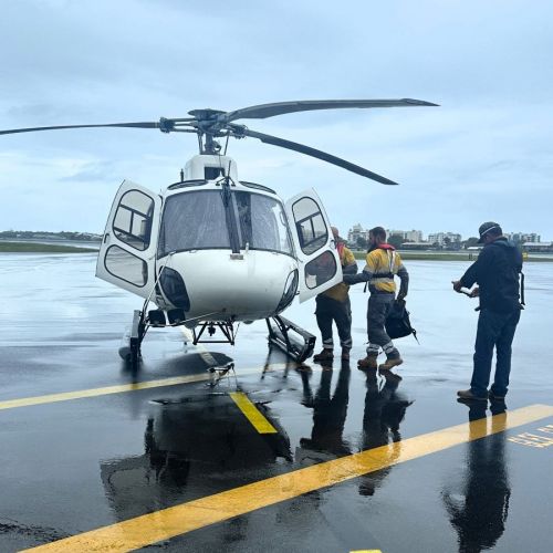 Crews walking to a helicopter on the tarmac