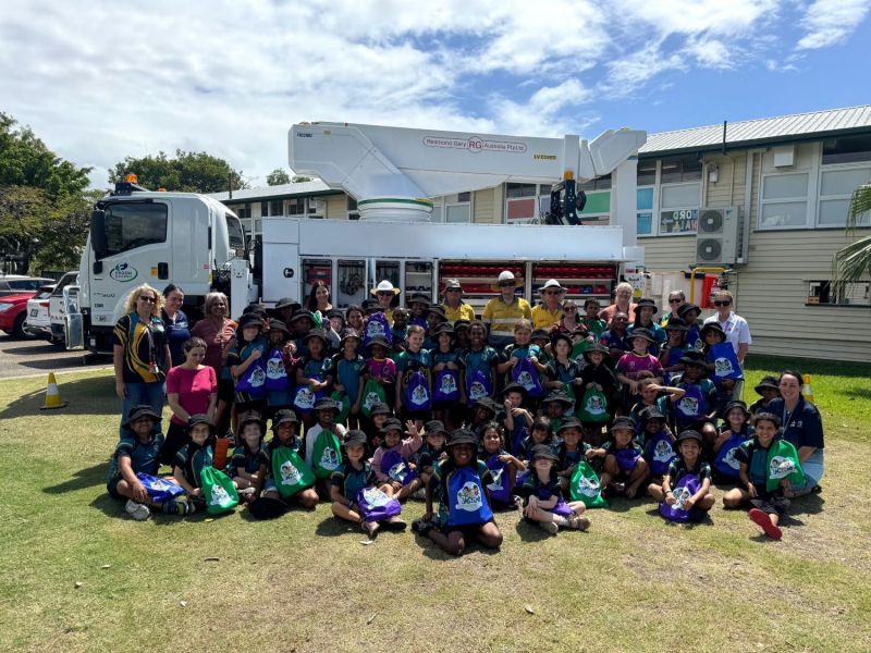 School children sitting in front of Ergon truck for Safety Heroes program