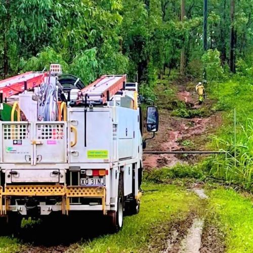 Field crew in the bush with work truck